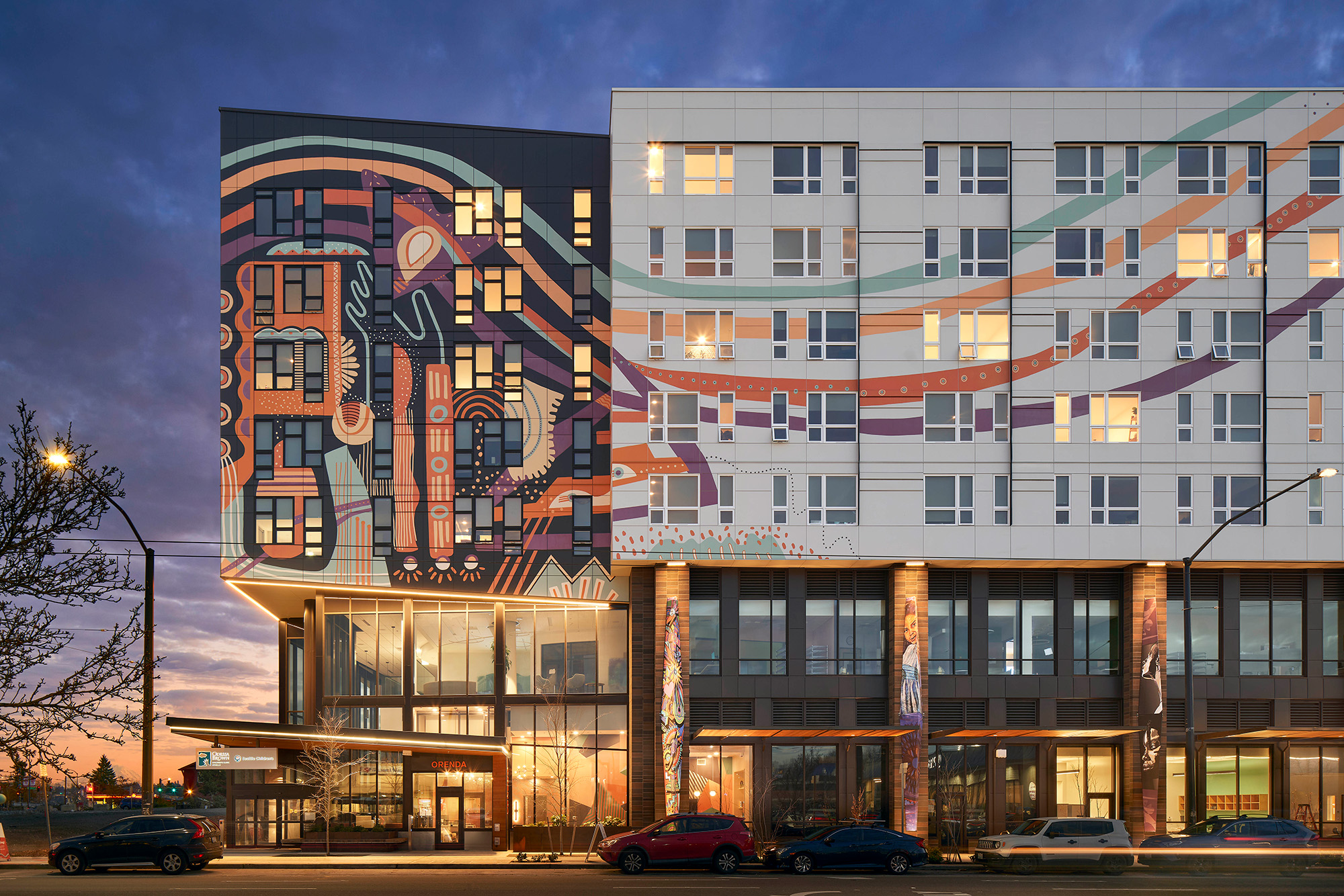 Affordable housing multifamily development with artistic exterior at night